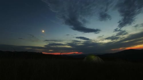 Nightfall Over Tent in Rural Mountain Landscape