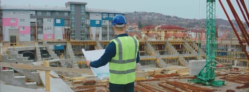 Construction Workers Plan Building Project at Construction Site