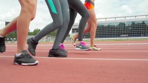 Athletes Running on Track on a Sunny Day