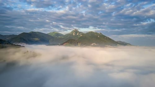 Mountains Peak Above Fog in Aerial View