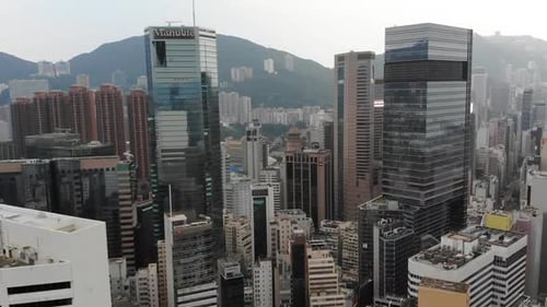 Hong kong island with view of buildings and hill, drone flying forward