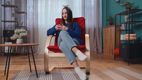 Woman Relaxing at Home with Smartphone