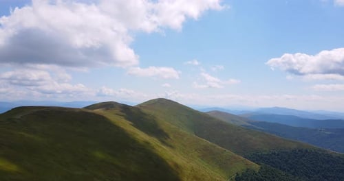 Aerial View of Green Mountains and Cloudy Sky