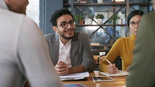 Diverse Colleagues Talking with Business Partners on Lunch in Restaurant