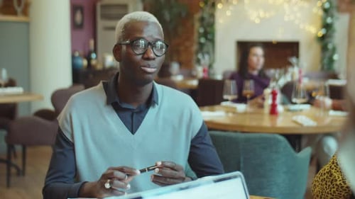 African American Coworkers Discussing Business in Cafe