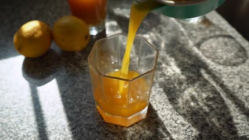 Pouring Freshly Squeezed Citrus Juice Into Glass