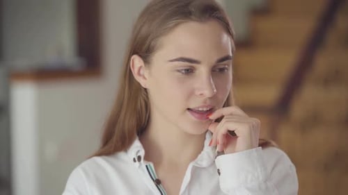 Young Woman Smiling and Thinking Indoors