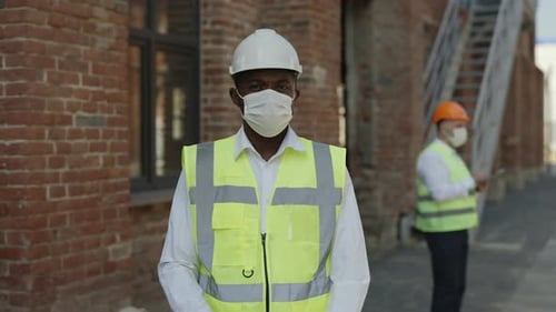 Construction Worker Wearing Safety Gear with Arms Crossed