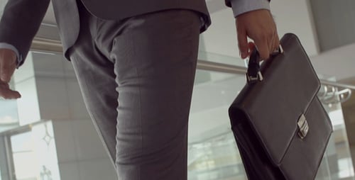 Businessman Walking up Stairs with Briefcase