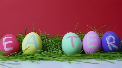 Colorful Easter eggs on a red background. Easter concept. Stop motion video.