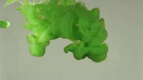 Vibrant Green Ink Flowing in Water