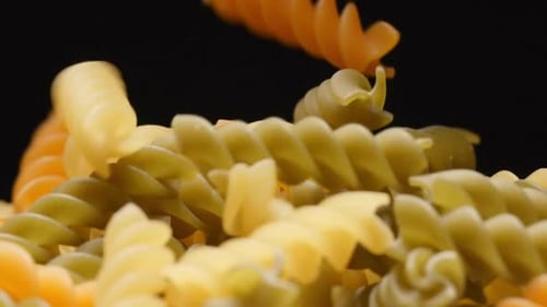 Colorful Rotini Pasta Falling in Close Up Shot