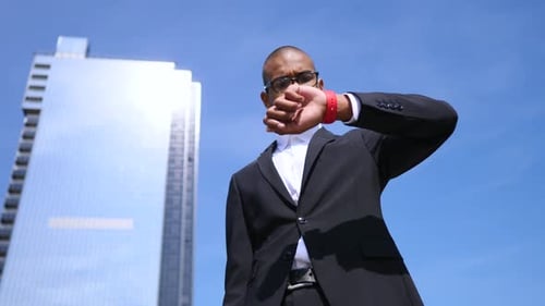 Man in Suit Checks Smart Watch in City