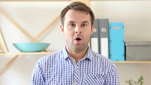 Amazed By Surprise Man Sitting in Office