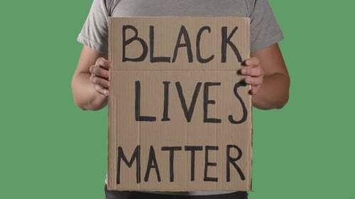 Person Holds Black Lives Matter Sign on Green Screen