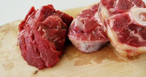 Raw Meat Cuts on Wooden Cutting Board