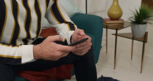 Person Using Smartphone: Scrolling and Interacting with Mobile Device