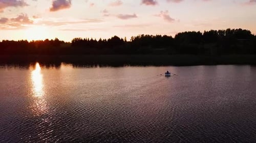 Man on Paddle Boat on a Lake