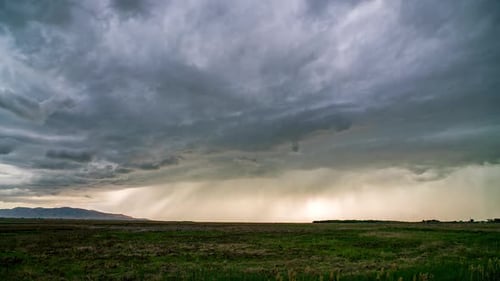 Rain storm moving over the marsh on Utah Lake through the valley