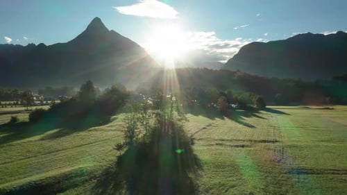 Sunrise Over Green Fields and Mountains