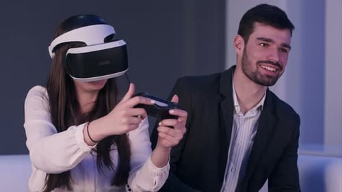 Woman Playing VR Game While Man Checks Phone