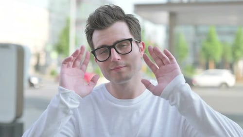 Young Adult Gesturing in City Setting