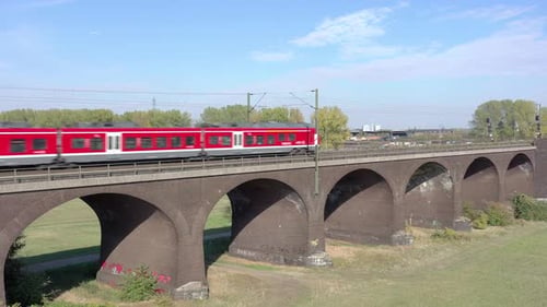 Commuter Train Passing Fast Over an Old Bridge