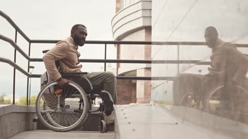 Black Man with Disability Riding Wheelchair Outdoors