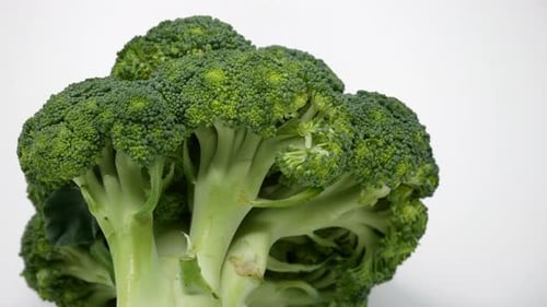 Fresh Green Broccoli Rotating on White Background