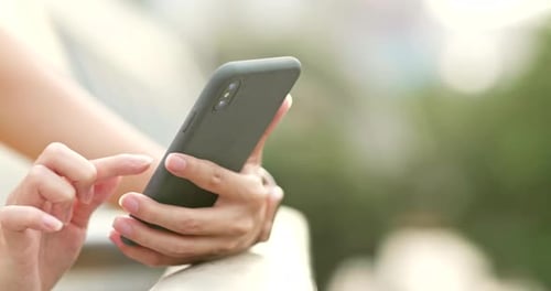 Close up of woman use of mobile phone in the evening