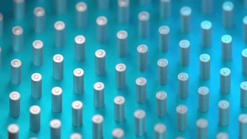 Futuristic Field of Silver Cylinder Batteries on Turquoise Surface