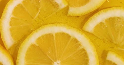 Top view rotation of fresh slice of lemons juice and gel serum