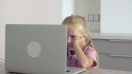 Girl Looking at Laptop in Bright Home Setting