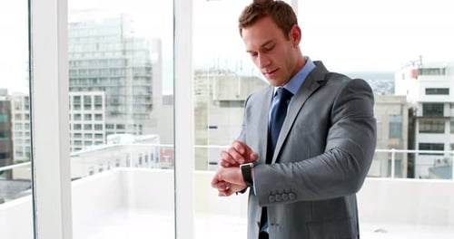 Handsome Businessman Using his Smart Watch