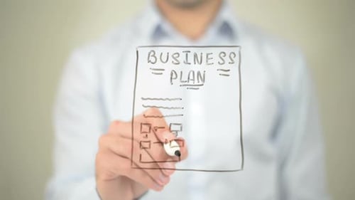 Drawing Business Plan on Clear Surface