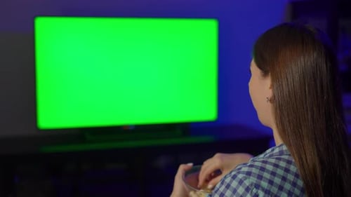 Woman Watches Green Screen TV Eating Popcorn at Night