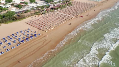 Aerial view of amazing beach with colorful umbrellas