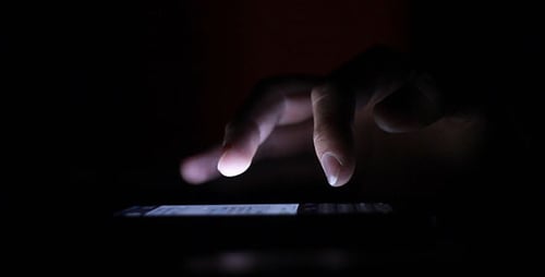 Hand Uses Phone in the Dark