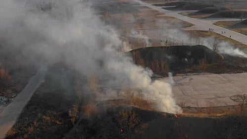 Aerial Top View of Epic Burning Dry Grass and Trees on a Spring Day Close To the Village at Sunset