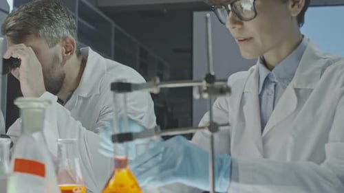 Scientists Conducting Research in Lab with Beakers