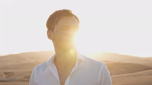 Brilho do sol brilhante no fundo com o homem explorando campos abertos em um dia ensolarado