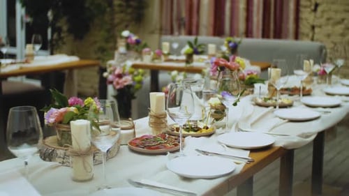 Elegant Wedding Table Setting with Flowers and Candles