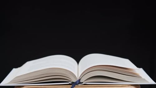 Pages Turning Rapidly in an Open Book