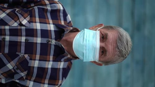Senior Adult Wearing Medical Mask Indoors