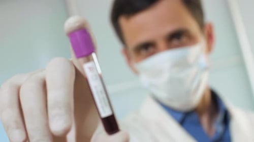 Healthcare Worker Holds Positive Coronavirus Blood Sample