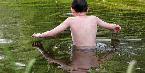 Boy Swimming Freestyle in Green Murky Lake