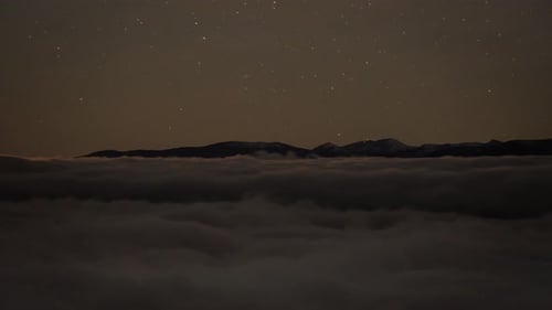 Starry Night Over Mountain Range and Cloudscape