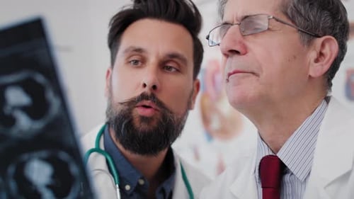 Handheld view of doctors examining the results of the radiology. Shot with RED helium camera