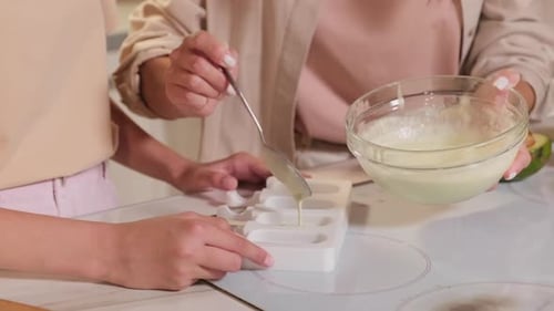 Pouring Ice Cream Mixture Into Forms