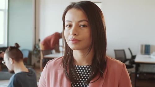 Beautiful Mixed Raced Woman Smiling at Camera at Work in Office
